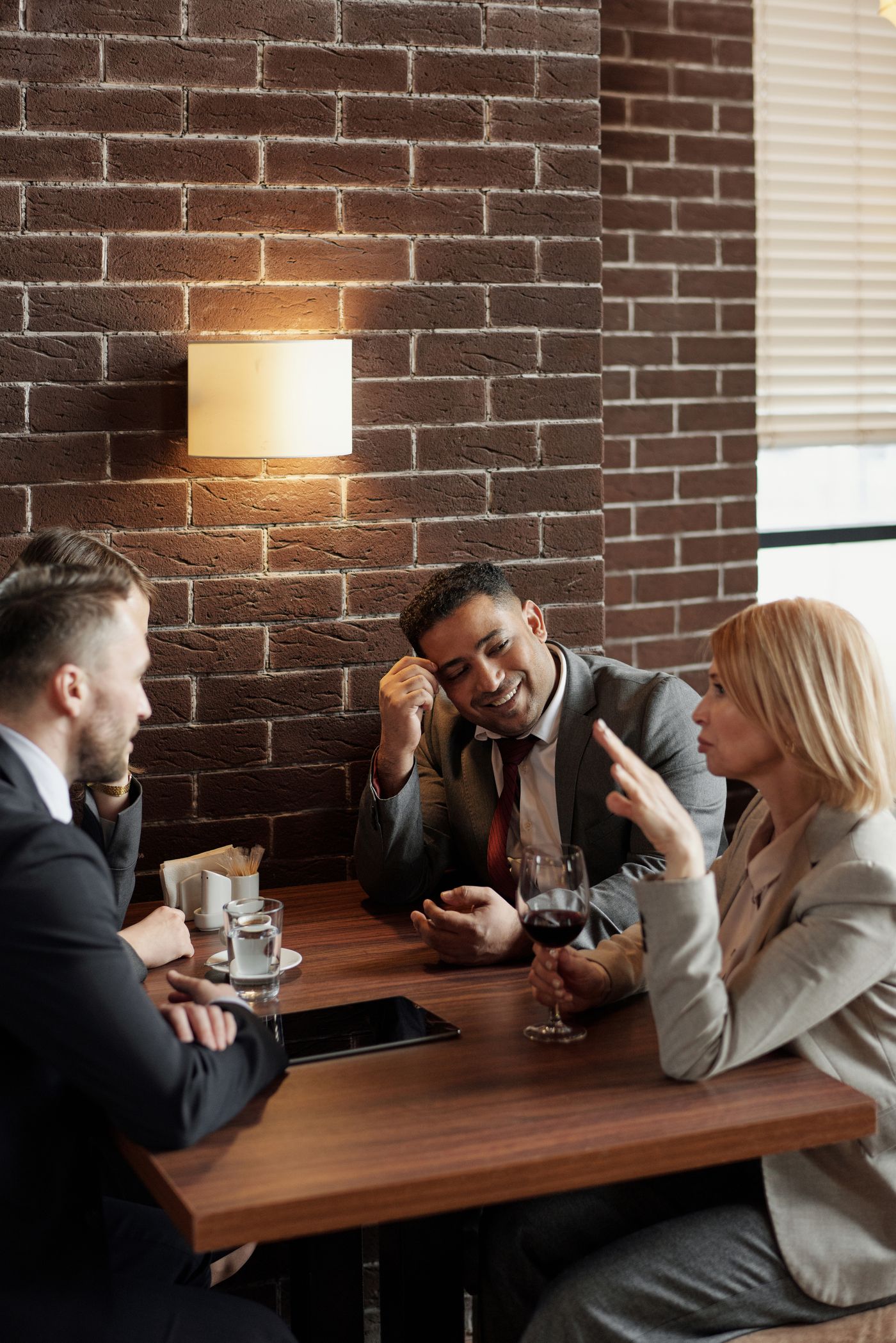 A group of professionals talking over drinks at a café