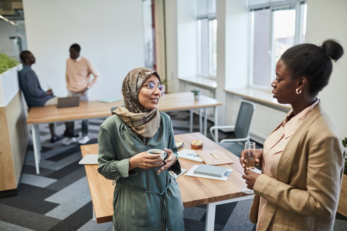 Professionals enjoying a relaxed conversation with drinks